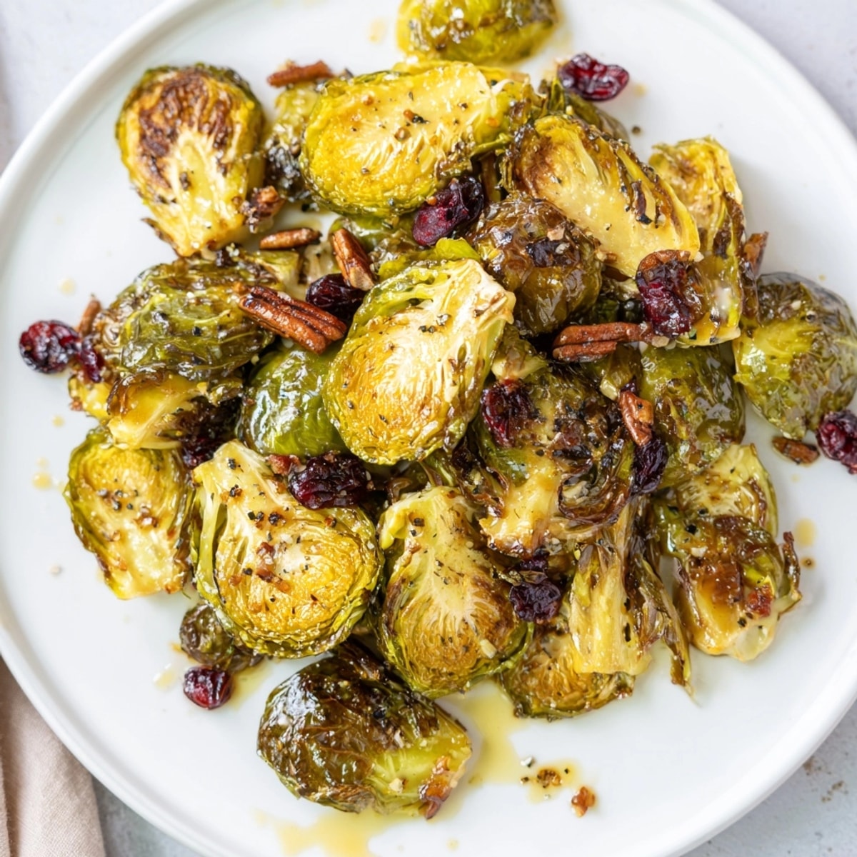 Golden Maple Glazed Roasted Brussels Sprouts on parchment, a sweet and savory side dish.