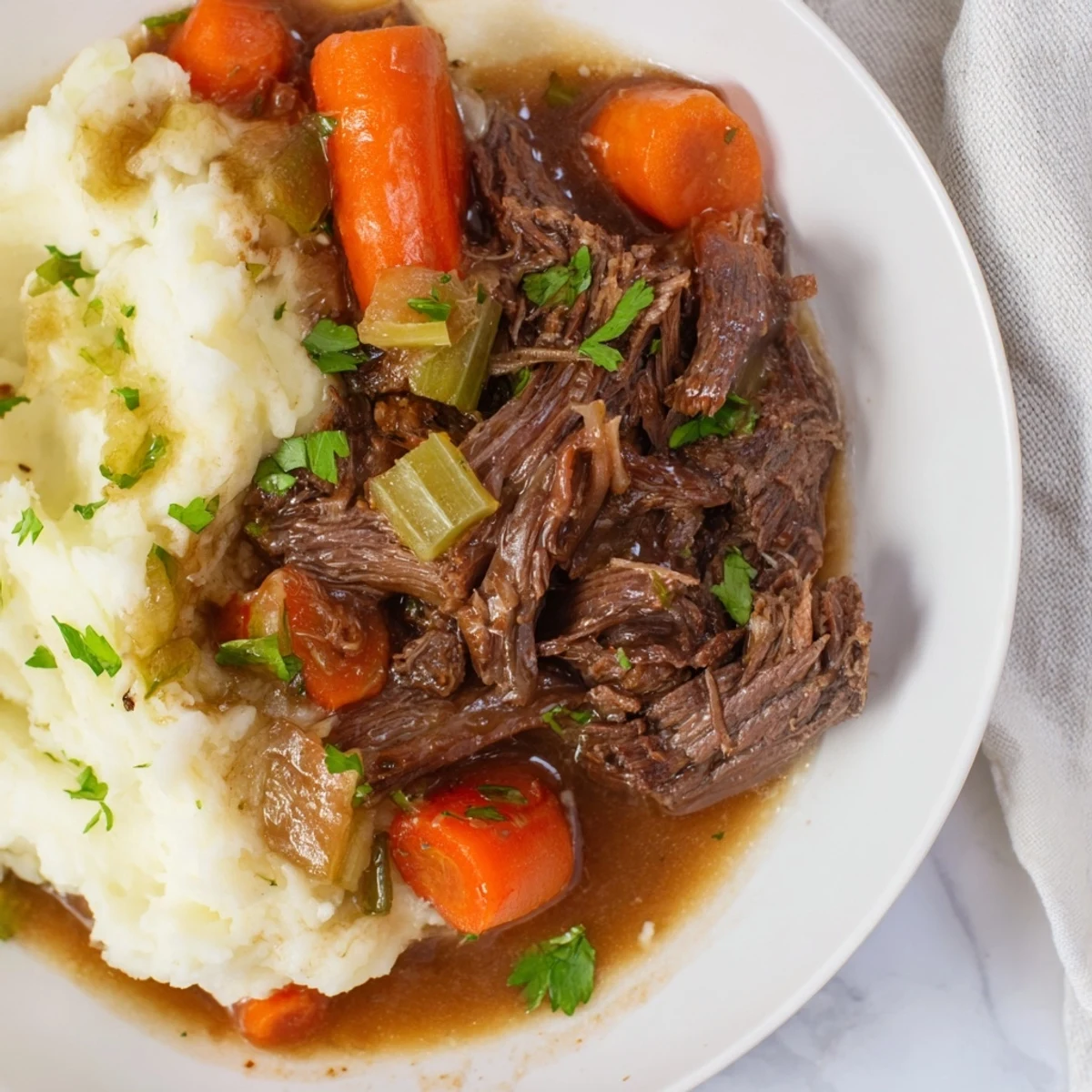 A close-up of the delicious Slow Cooker Pot Roast, perfect for a cozy, comforting American dinner.