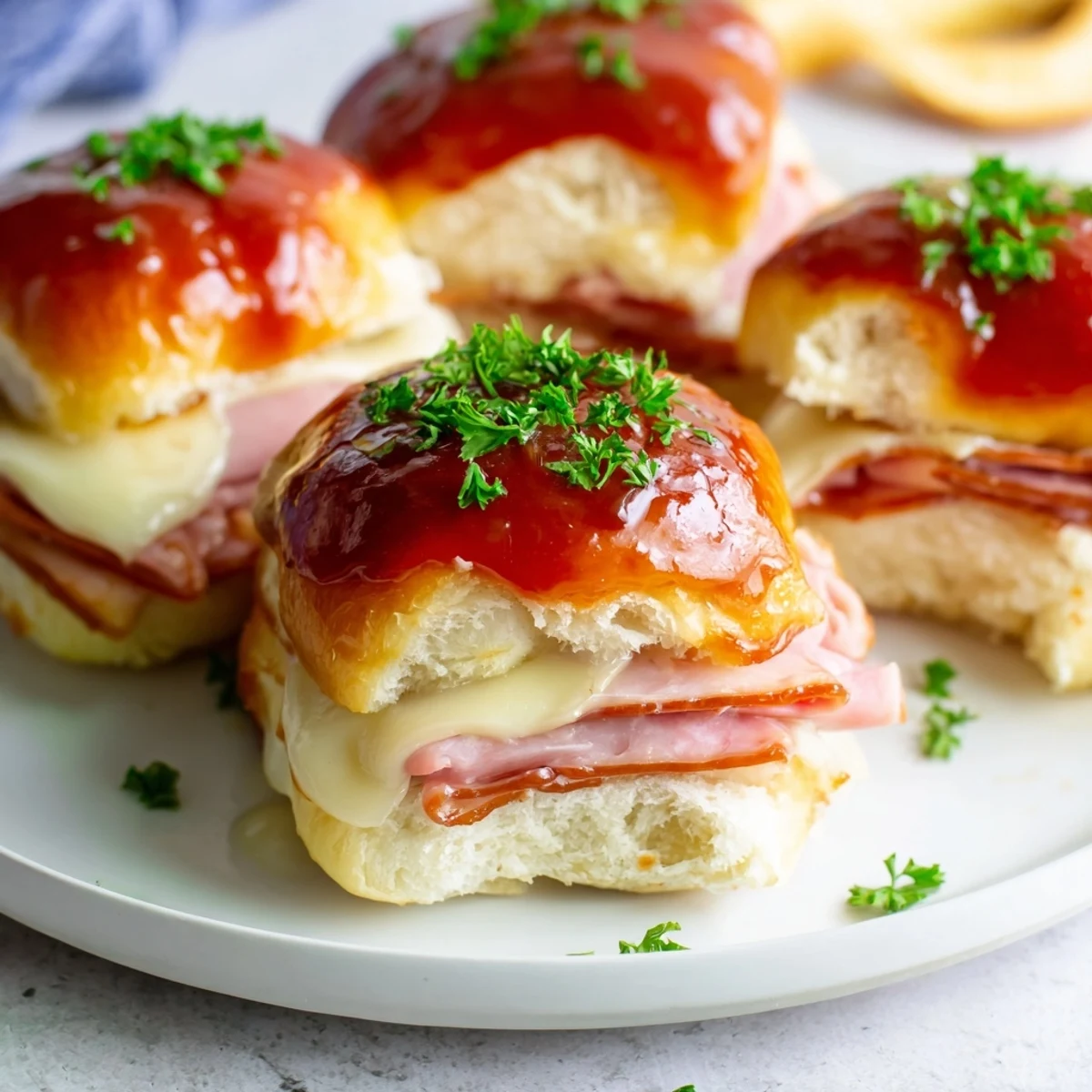 Close-up of a stacked Cherry-Glazed Ham and Cheese Slider, glistening with sweet and savory glaze.