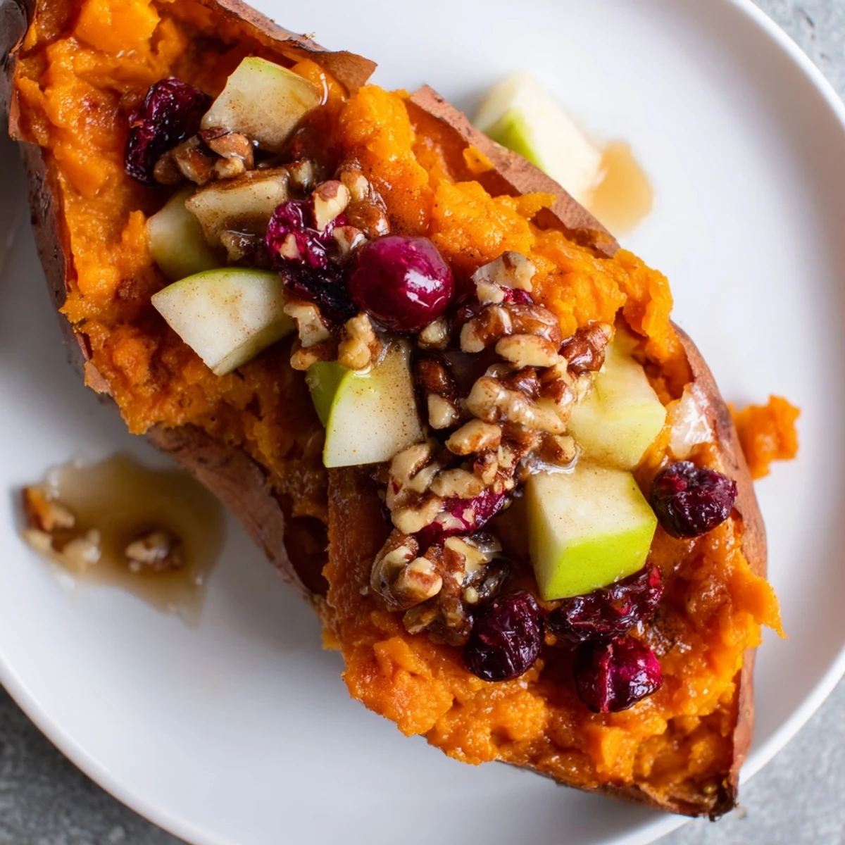 Golden, glistening Cranberry Apple Twice-Baked Sweet Potatoes, a warming autumn side dish served hot.