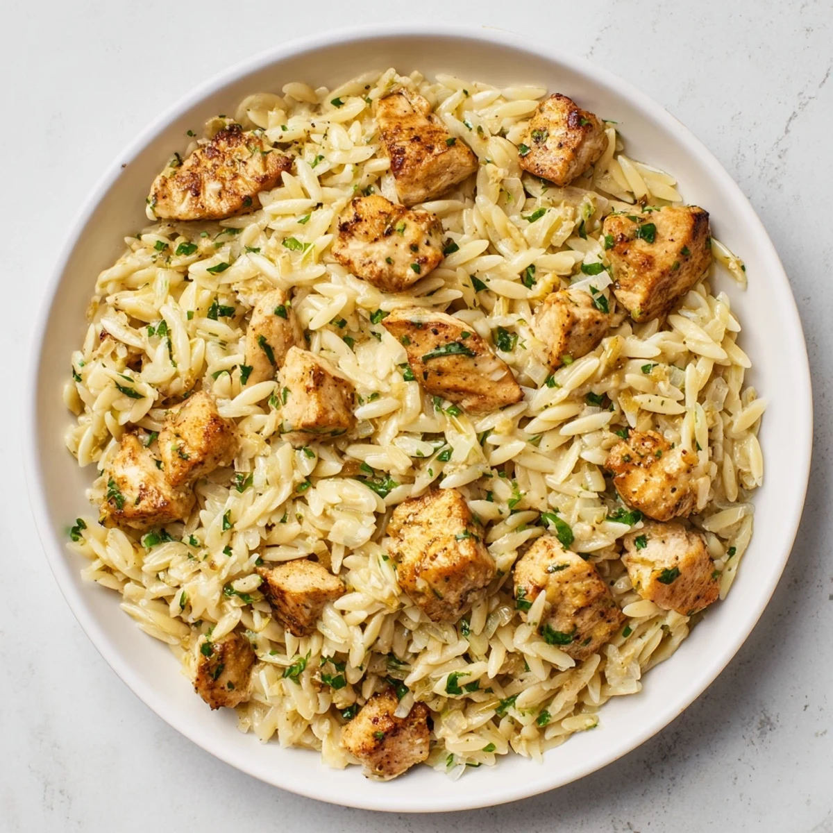 Creamy One-Pot Cajun Chicken Alfredo Orzo features tender chicken and zesty sauce, ready in 30 minutes.