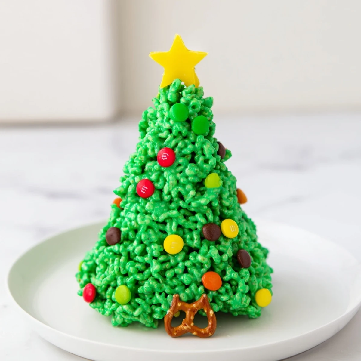 Perfectly shaped Christmas Tree Rice Crispy Treats, arranged on parchment; a delightful holiday dessert!