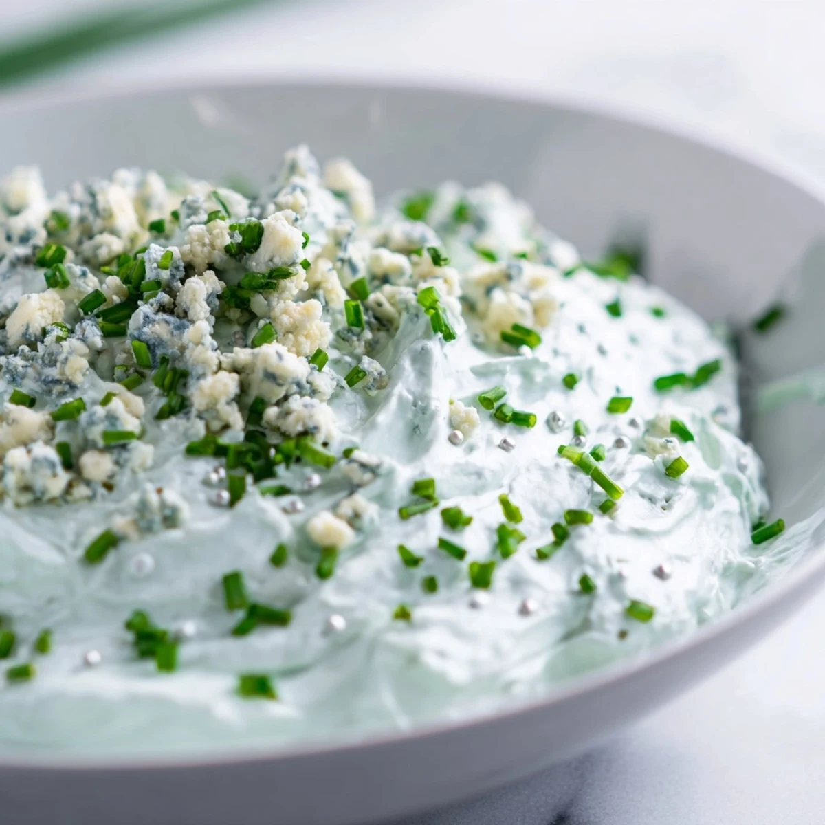 Frozen Pond Blue Dip Platter: a creamy blue cheese dip surrounded by colorful chips and fresh vegetables.