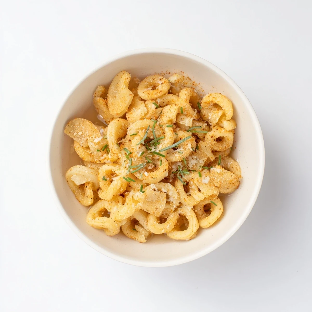 Close-up of a delightful serving of pasta chip cereal with warm broth and parmesan garnish.