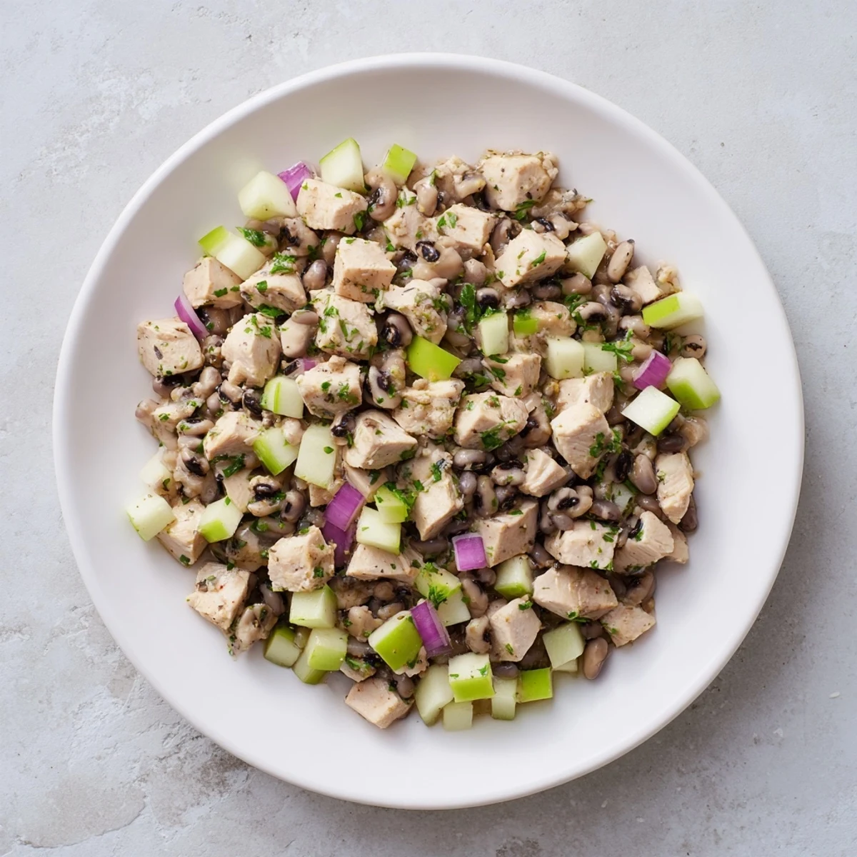 Chicken and Apple New Years Luck Salad, bursting with colorful ingredients, offers a refreshing bite.