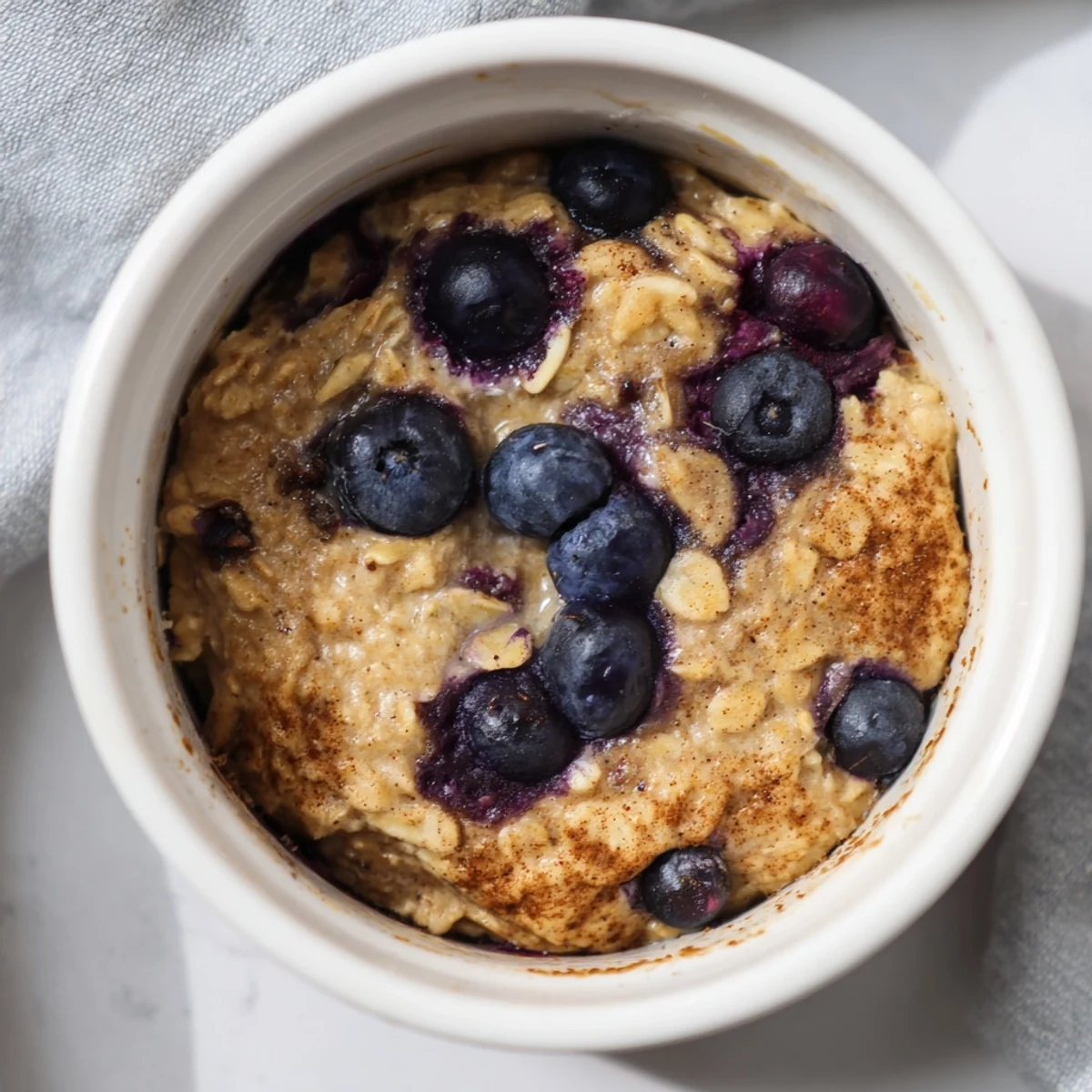 Golden-brown Blueberry Baked Oats, offering warm textures and the delightful taste of fresh blueberries.