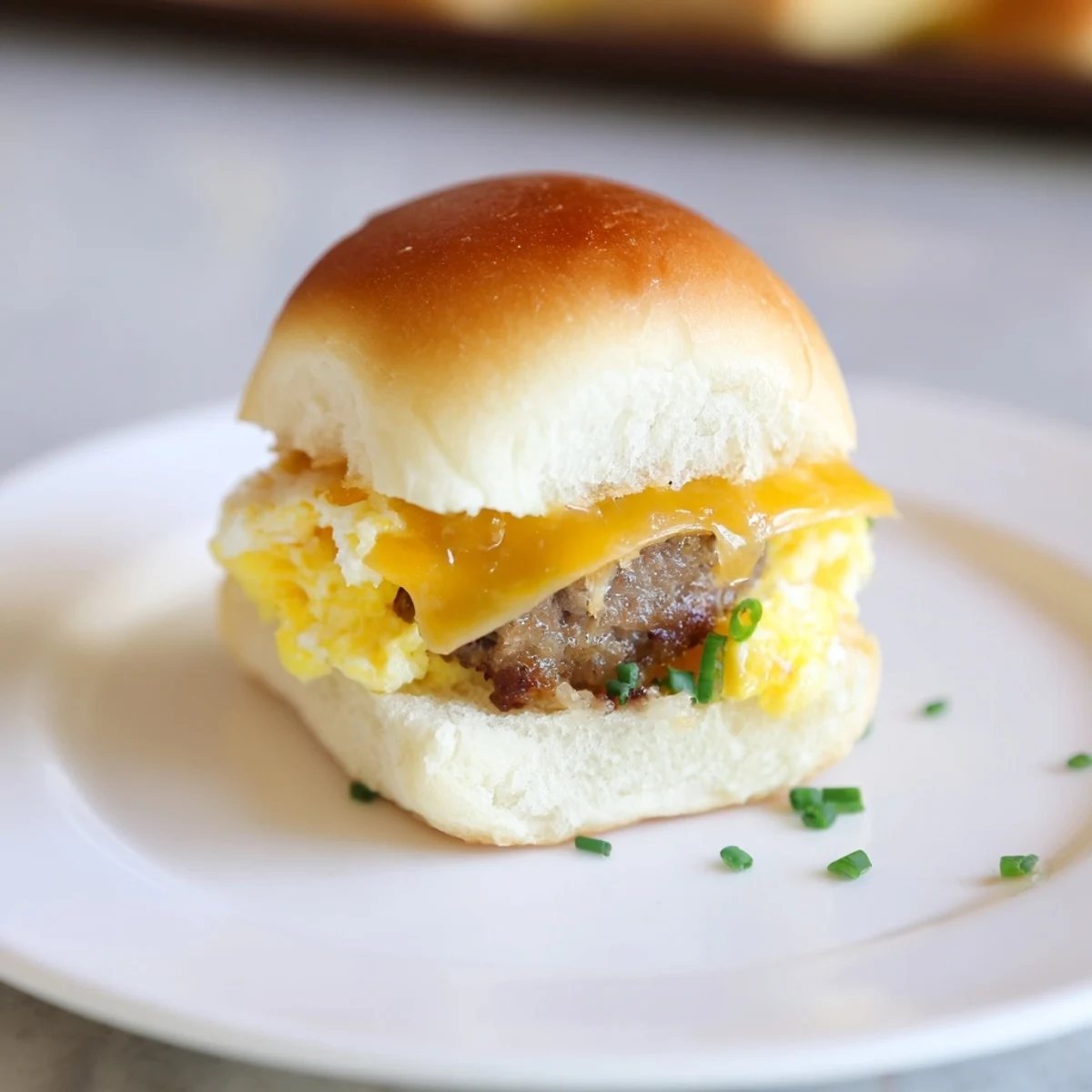 Golden, melted cheese oozes from warm Mini Breakfast Sliders, a perfect handheld brunch treat.