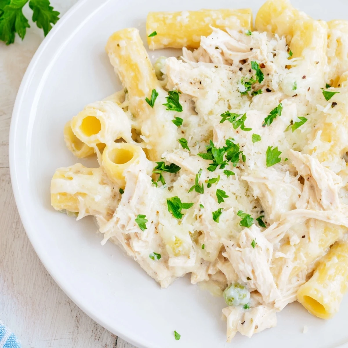 Savory slow cooker chicken Alfredo pasta bake featuring tender chicken and rich, cheesy sauce.