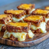 Cozy mini grilled cheese dippers alongside warm, creamy tomato soup for dipping.