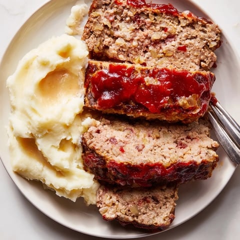 Savory meatloaf with creamy mashed potatoes, perfect for a cozy family meal.  
