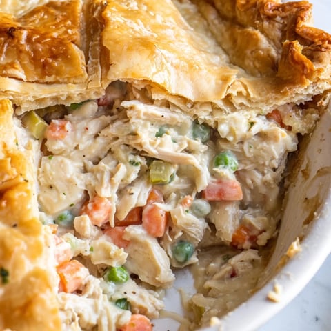 Golden-brown Classic Chicken Pot Pie with creamy filling and savory vegetables awaits you.
