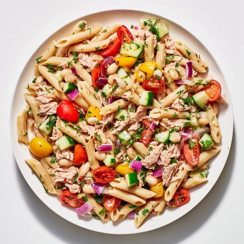 Flaky tuna and white beans mingle in this vibrant Spicy Tuna and White Bean Pasta Salad.