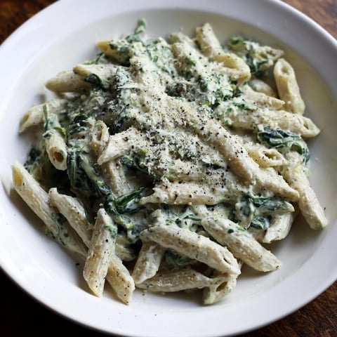 Creamy Cottage Cheese Spinach Pasta, ready to serve with Parmesan and fresh basil, looks so delicious.