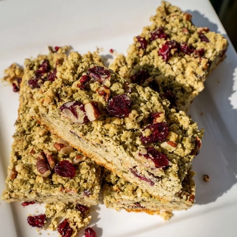 Golden-crusted Matcha Cranberry Oat Crumble Bars, offering a delightful mix of earthy matcha and sweet cranberries.