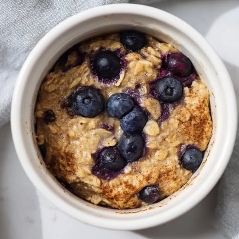 Golden-brown Blueberry Baked Oats, offering warm textures and the delightful taste of fresh blueberries.