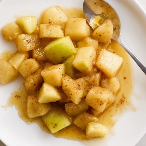 Warm, fragrant Slow Cooker Stewed Apples, sweetened with honey, look perfect served with granola.