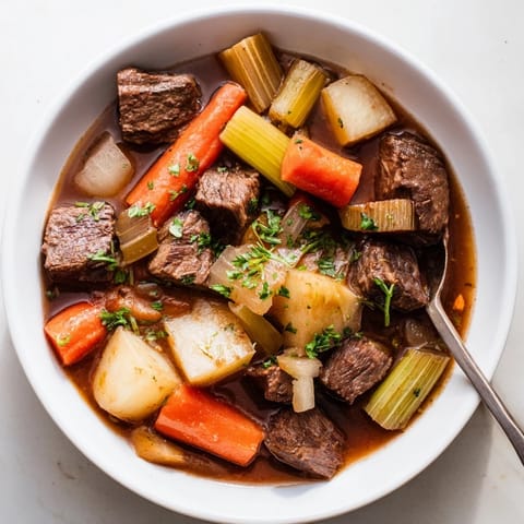 Tender beef stew featuring colorful root vegetables, perfect for cozy dinners.  