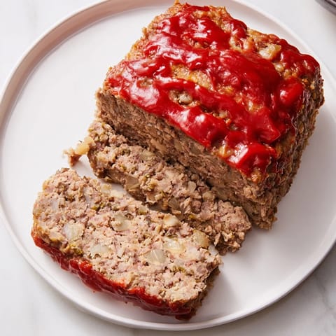 A close-up shot of the delicious Stove Top Stuffing Meatloaf, perfectly baked and glistening on top.
