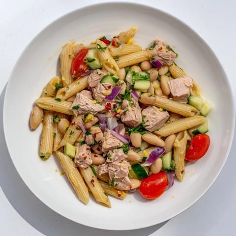 Cool, refreshing Spicy Tuna and White Bean Pasta Salad with a zesty chili-lime dressing beckons.