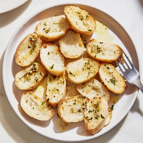 Crispy Simple Bread baguette rounds, slightly overlapping in a decorative pattern on a baking sheet.