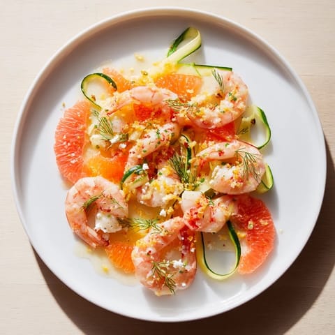 Showcasing The Coral Reef: a pescatarian delight with citrus, shrimp, and bubbly cheese, ready to eat.
