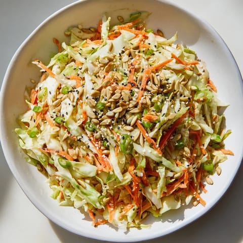 Freshly tossed Cabbage-Core Slaw Salad with toasted seeds, perfect for a light and refreshing meal.