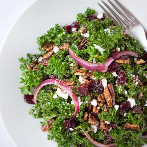 Freshly massaged kale leaves glistening with warm maple-mustard dressing, topped with crunchy toasted pecans and sweet dried cranberries in this vibrant warm kale salad.