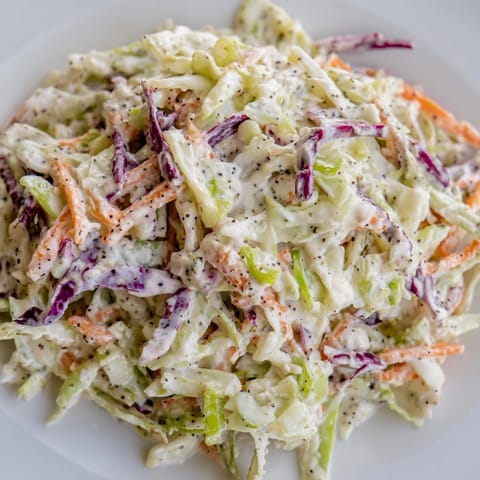 Vibrant Best Cabbage Coleslaw in a white bowl, perfect for a summer barbecue side dish.