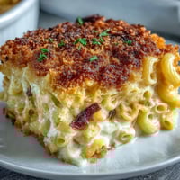 Baked creamy mac and cheese with golden panko topping, bubbling with rich cheddar and Gruyère sauce.